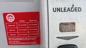 Signs on gas pumps at Giant Eagle on North High Street in Clintonville list federal and state gas taxes.