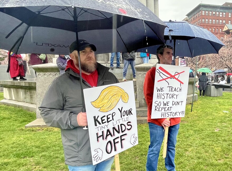Rain drips from the umbrellas of two demonstrators on Lackawanna County Courthouse Square during Saturday's 'Hands Off!' rally.