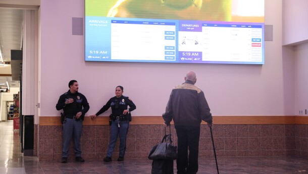 A passenger checks arrival and departure times at the El Paso International Airport after the FAA grounded flights for several hours.