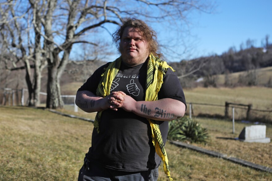 Cody (last name omitted), a member of a III% affiliated militia, looks for distant family member's grave sites in the mountains south of Roanoke, Virginia, U.S., January 23, 2021. Jim Urquhart for NPR