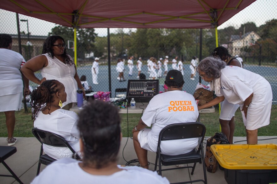 Paula Allen, "Queen Poobah," operates the music for the dance night.