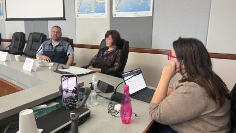 KUCB's Sofia Stuart-Rasi moderating the annual City Council candidates Forum on Thursday, Sept. 25, 2025. Zac Schasteen, pictured left, and Katherine McGlashan, middle, are running for City Council Seat C against Incumbent Darin Nicholson, not pictured.