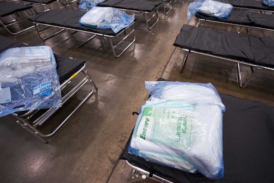 Cots are staged for setup as Texas Army National Guardsmen set up a field hospital in response to the new coronavirus crisis at the Kay Bailey Hutchison Convention Center on March 31, 2020, in Dallas. 