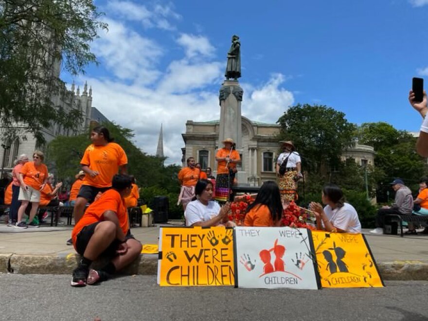 Members of the Onondaga Nation in the shadow of Syracuse's statue of Christopher Columbus during a rally Saturday, July 31, 2021