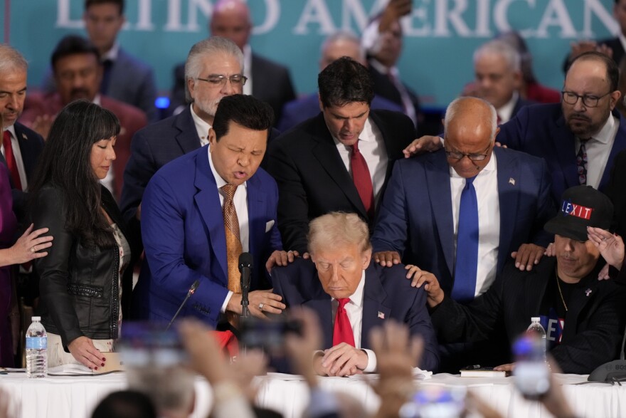 Latino leaders pray with Republican presidential nominee former President Donald Trump, front center, as he participates in a roundtable with Latino leaders Tuesday, Oct. 22, 2024, in Doral, Fla.
