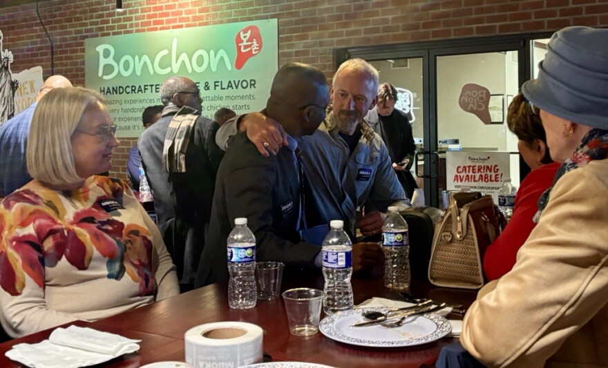 Bloomington Mayor Mboka Mwilambwe with supporters at his watch party Tuesday night at Bonchon.