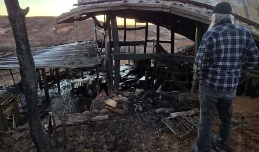 Joe surveys the destruction of his house after the fire. Thank you for helping him rebuild.