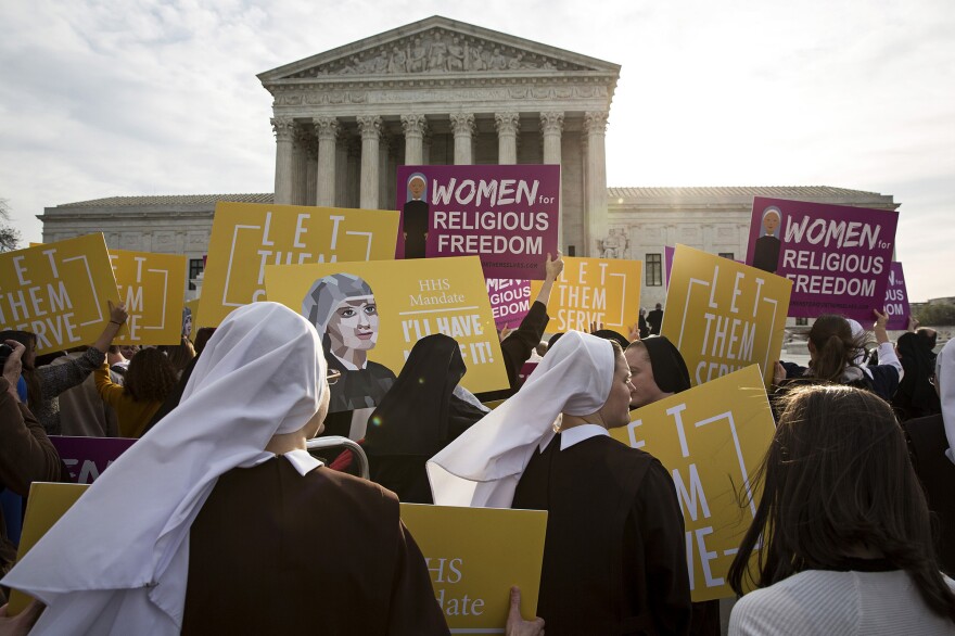 Nuns and others opposed to the Affordable Care Act's contraception mandate rally outside the U.S. Supreme Court Wednesday.