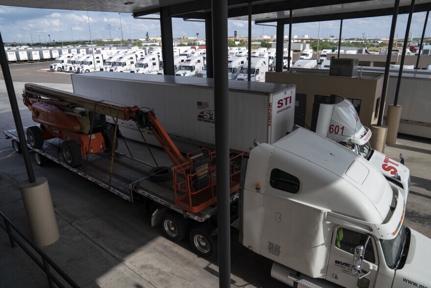 Trucks leave Super Transport International’s warehouse on Friday, May 31, 2019 in Laredo, Texas.