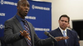 Florida Surgeon Gen. Dr. Joseph A. Ladapo, left, speaks at a news conference with Florida Gov. Ron DeSantis, right, Monday, Jan. 3, 2022, at Broward Health Medical Center in Fort Lauderdale, Fla. (AP Photo/Wilfredo Lee)