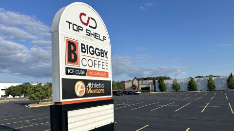The sign in front of the Biggby Ice Cube in Texas Township advertises the facility an adjoining restaurant, CD Top Shelf.