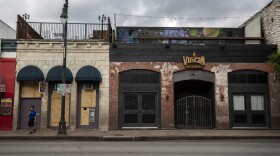 Bars and restaurants on Sixth Street are closed and boarded up during the coronavirus pandemic. 