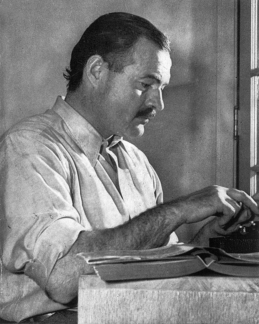 Hemingway posing for a dust jacket photo by Lloyd Arnold for the first edition of "For Whom the Bell Tolls", at the Sun Valley Lodge, Idaho, in December 1939.