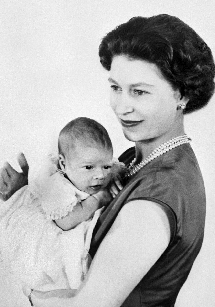 One of the first pictures of Prince Andrew, shown in the arms of his mother, Queen Elizabeth II. He was born in 1960.