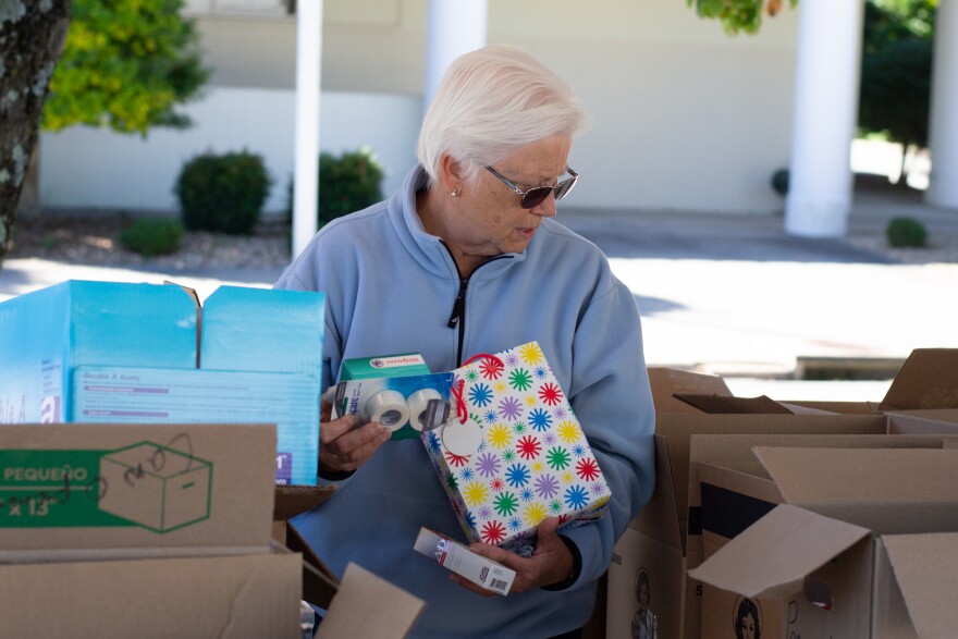 Betty Almarode organizes first aid supplies into boxes.