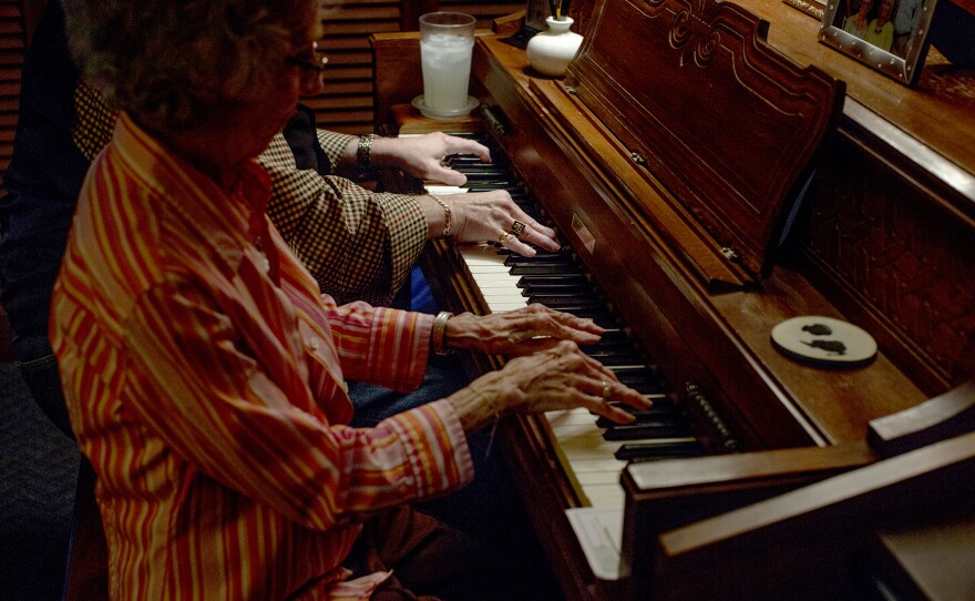 Richard Langford and his mother Leta Langford, play the piano together at their home in East Nashville. Richard almost died a decade ago and still suffers some cognitive symptoms, but he says music keeps him going.