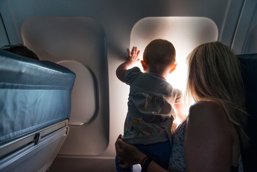 The window seat may be a safer spot for small children than along the aisle. Plus there's the view.