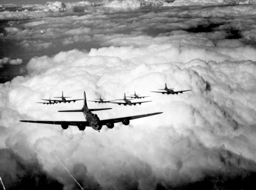B-17s in tight formation over the clouds