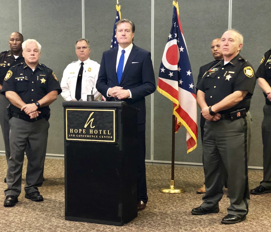 Congressman Mike Turner (R-10) is flanked by Montgomery County Sheriff Phil Plummer (left), Green County Sheriff Gene Fischer (right) and other law enforcement officials at a press conference at WPAFB.