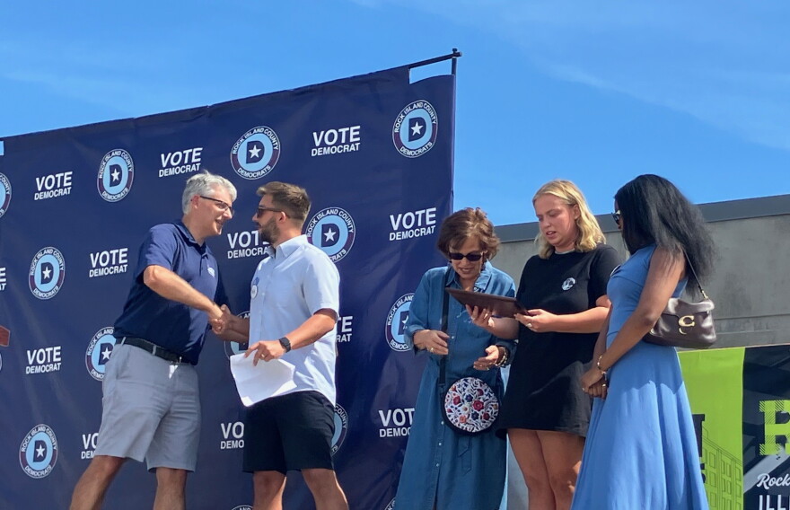 Mike Halpin (left) shakes hands with Jack McNeil, son of award winner Porter McNeil. With them are Porter's wife, Mary, daughter Ellie, and Jack's wife Kamelotte.