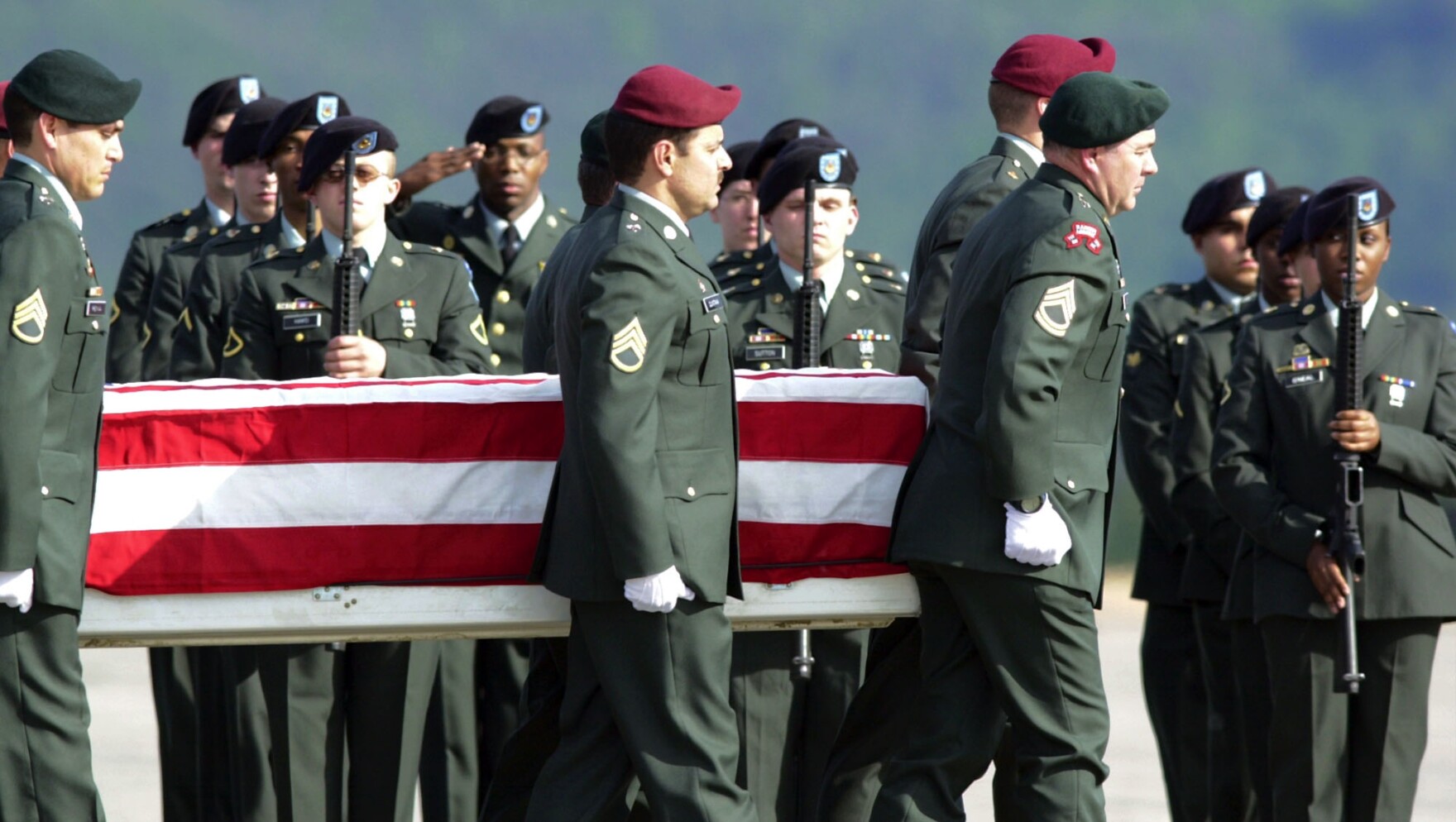 US Army honor guards carry a flag-draped coffin with the remains of Sgt. Gene Arden Vance Jr. from Morgantown, West Virginia, off a C-17 plane at the Ramstein, western Germany, US Air Base, Monday May 20, 2002.