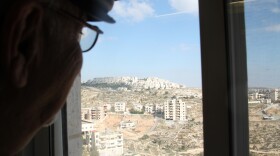 Jad Isaac surveys the Har Homa settlement from his office window. Isaac, director of a Palestinian organization for sustainable development, is encouraged by Secretary of State John Kerry's impassioned defense of the U.N. Security Council's condemnation of the Israeli government's construction of Jewish settlements in the West Bank.