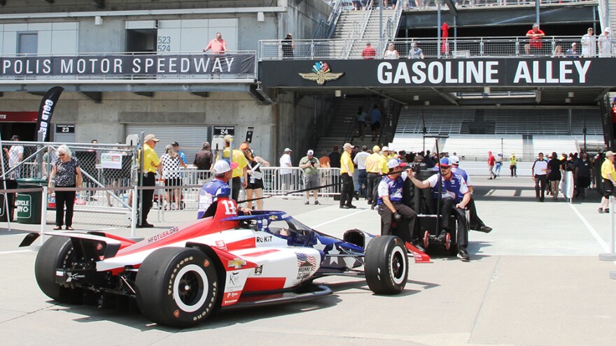 Crew members tow JR Hildebrand's car from the garages to pit lane ahead of practice session for the Indianapolis 500 on Friday, May 22.