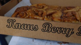A dozen Knaus Berry Farm cinnamon rolls in a cardboard box.