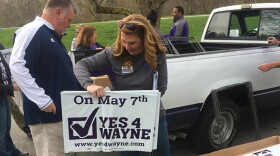 Volunteers distribute signs for Wayne Township Schools ahead of the May 2019 election.