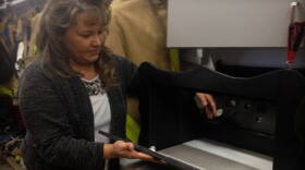 Monica Kelsey opens the baby box prototype in this 2015 file photo.