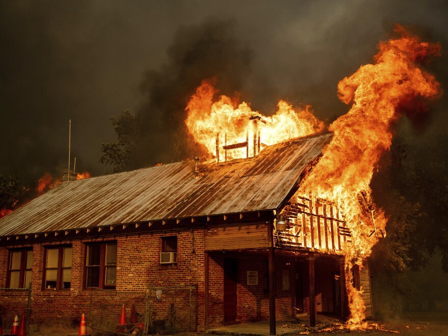 A historic schoolhouse burns as the Carr Fire tears through Shasta, Calif., on Thursday, fueled by high temperatures, wind and low humidity.