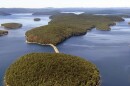 In this September 2013 aerial file photo provided by the Massachusetts Deptartment of Conservation and Recreation, a dirt and stone road leads to Mount Zion Island, at rear, at the Quabbin Reservoir in Petersham, Mass.