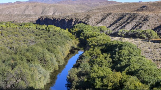 The Gila River flows near Safford, Arizona on October 30, 2020. This year, intensely dry conditions are forcing the town of Kearny to take major cutbacks. Kearny's mayor said they could cause taps to go dry as soon as July.