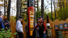 The chief of the Valdez Native Tribe Bill Smith (right) and other veterans unveil a new monument at the Alaska Native Heritage Center’s Ngíisdla Garden on Sunday, Sept. 27.