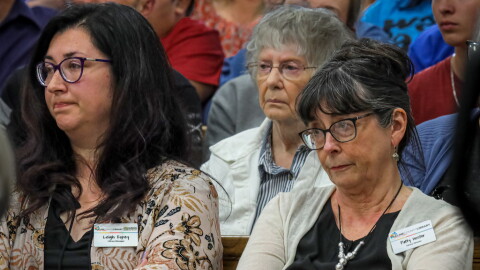 Patty Hector (right), director of the Saline County Library, listens during public comment on a resolution that would restrict children's access to books that contain "sexual content or imagery" at an April 17, 2023, meeting of the county quorum court. The court adopted the resolution and later approved an ordinance in August that led to Hector's firing in October. Leigh Espey (left) became interim library director.