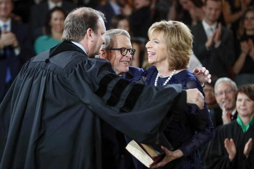 The DeWine's do a group hug after the oath of office.