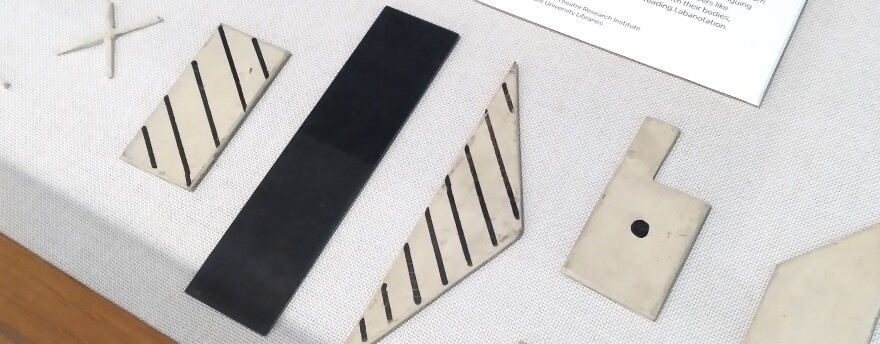 six tactile Labanotation symbols in a display case