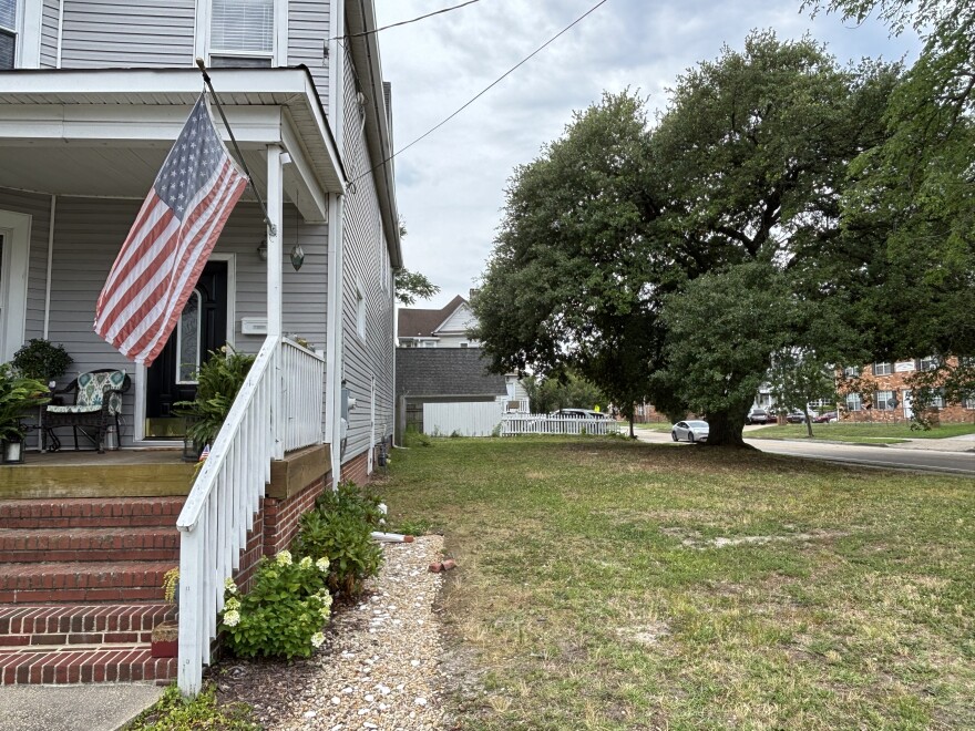 The live oak tree on a vacant lot next to Burrows' and Rawlinson's home in Norfolk's Park Place, seen on June 16, 2026.