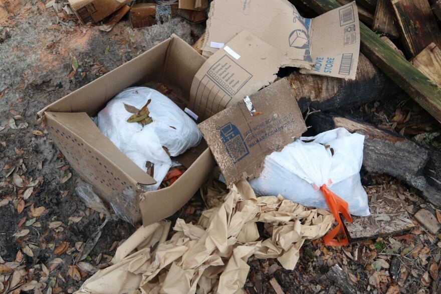 Dead animals were found in sealed trash bags on top of a burn pit on the property.