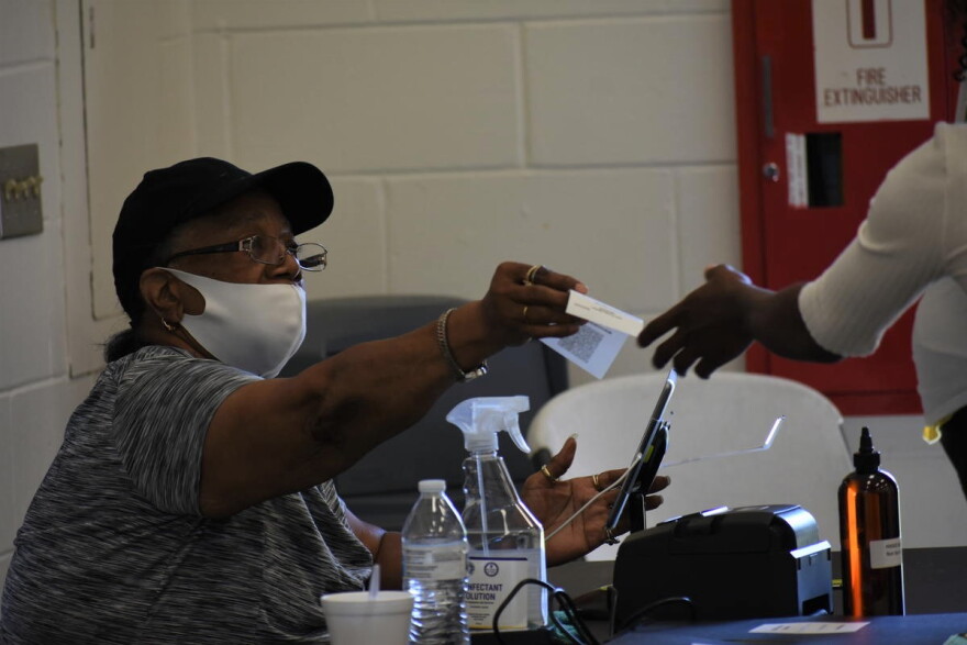 The poll worker seen from June isn't wearing their mask correctly, blunting its effectiveness at halting COVID-19's spread.