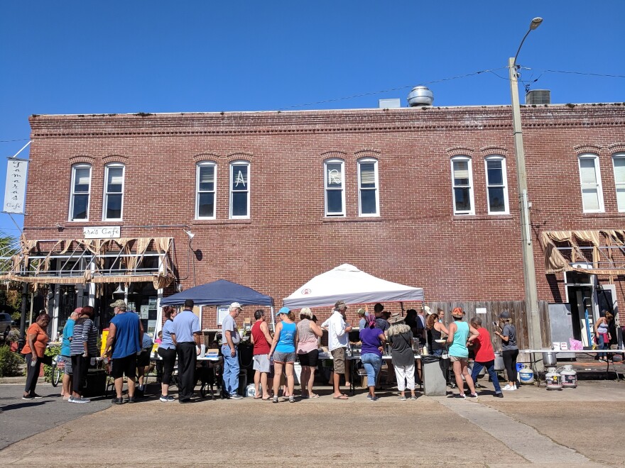 Volunteers serve meals to residents of Apalachicola and Eastpoint, where hot food is hard to come by because of power outages.