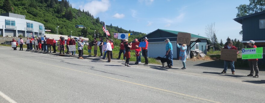Community members line Bartlett Street in Homer on Wednesday, June 18, 2025, to protest proposed federal Medicaid cuts. The march ended near South Peninsula Hospital.
