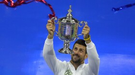 Novak Djokovic, of Serbia, holds up the championship trophy after defeating Daniil Medvedev, of Russia, in the men's singles final of the U.S. Open tennis championships, Sunday, Sept. 10, 2023, in New York. (AP Photo/Mary Altaffer)