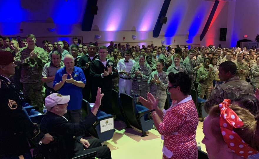 Nine veterans received standing ovations from the audience as they entered the theater at MacDill Air Force Base for the ceremony. Their names and a summary of their service in WWII were read as each person entered the room. 