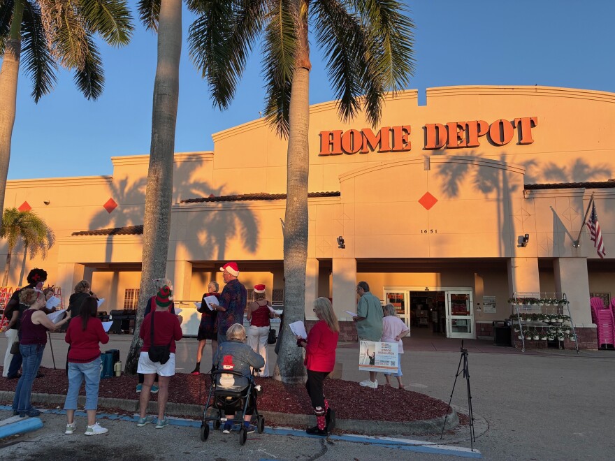 Members of the Southwest Florida Indivisible group protest outside the Home Depot in Naples, Florida, on Saturday, Dec. 20, 2025.
