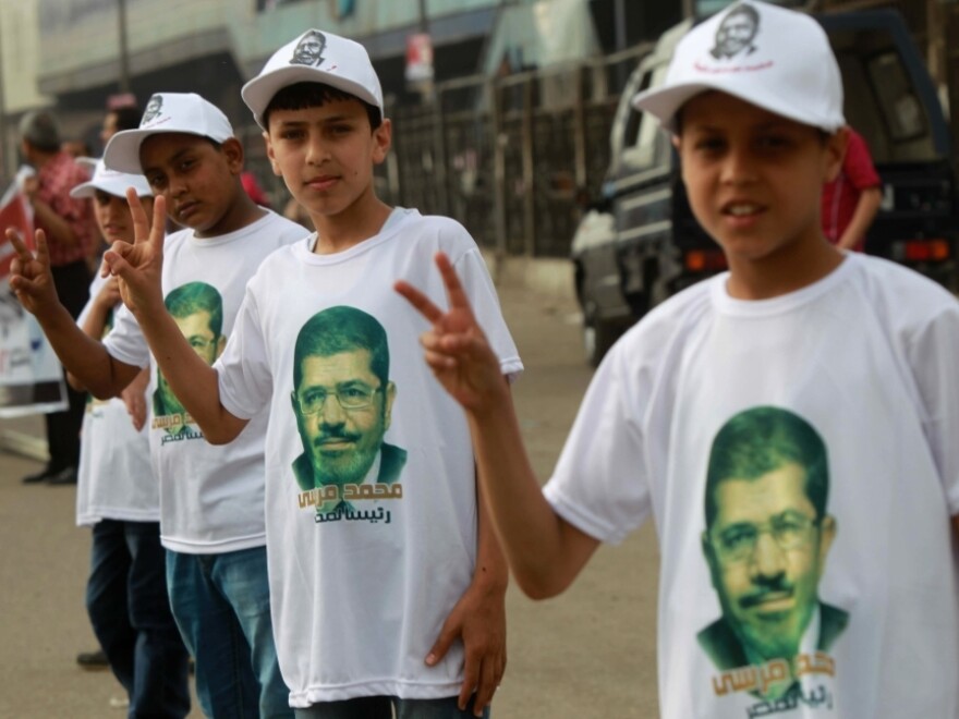Among the candidates in Egypt's presidential election is Mohammed Mursi of the Muslim Brotherhood. Here, his young supporters campaign for him on the outskirts of Cairo on Thursday.