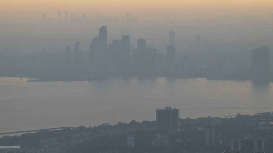 Smoke and haze from wildfires in the provinces of Quebec and Nova Scotia blurs the cityscape of Toronto in late June.