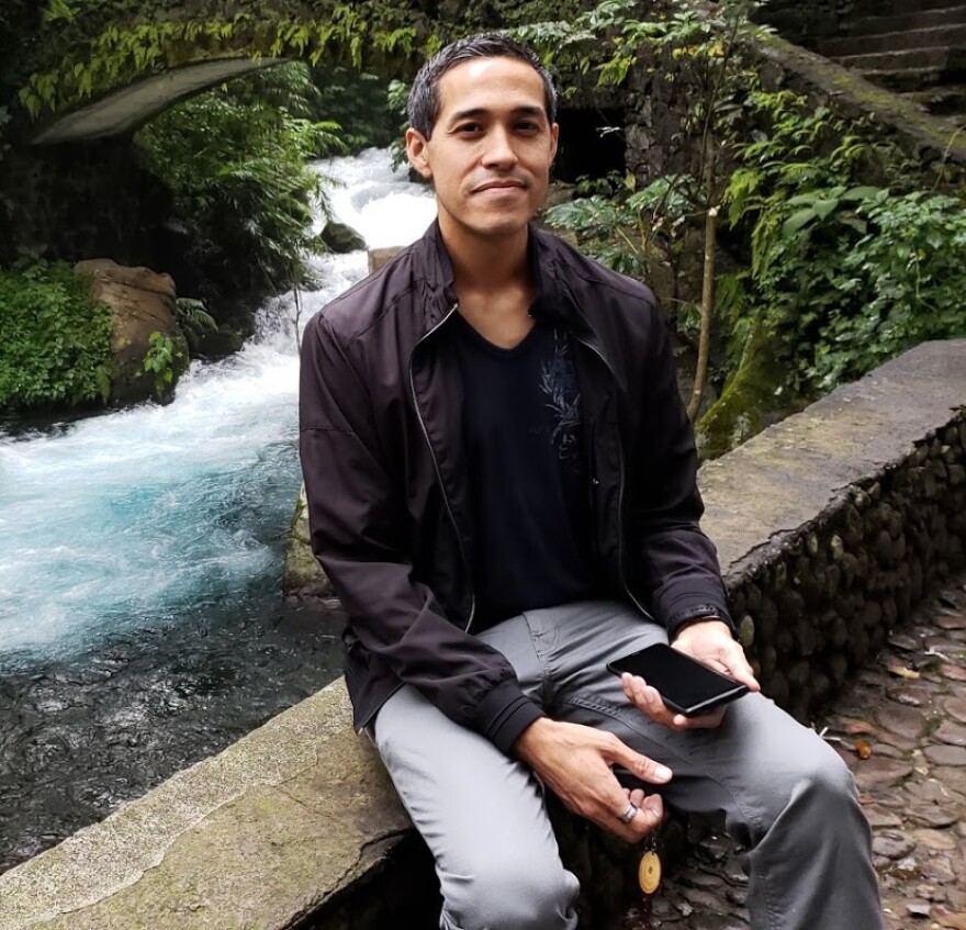 Veteran Sergio Alfaro sits in front of a river.