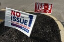 Signs for and against Ohio Issue 1 dot the landscape in Columbus.