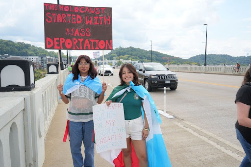 Protestors Estrella Lopez and Stefania Vasquez Lopez held up signs protesting federal immigration enforcement policies during Indivisible Knoxville’s Labor of Love protest on September 1, 2025.